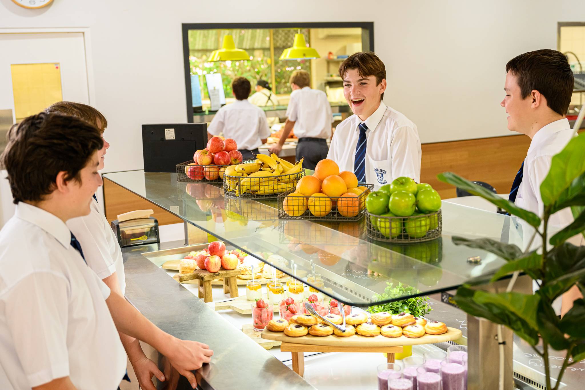 Students at Mazenod College Perth WA boarding in the kitchen eating food.