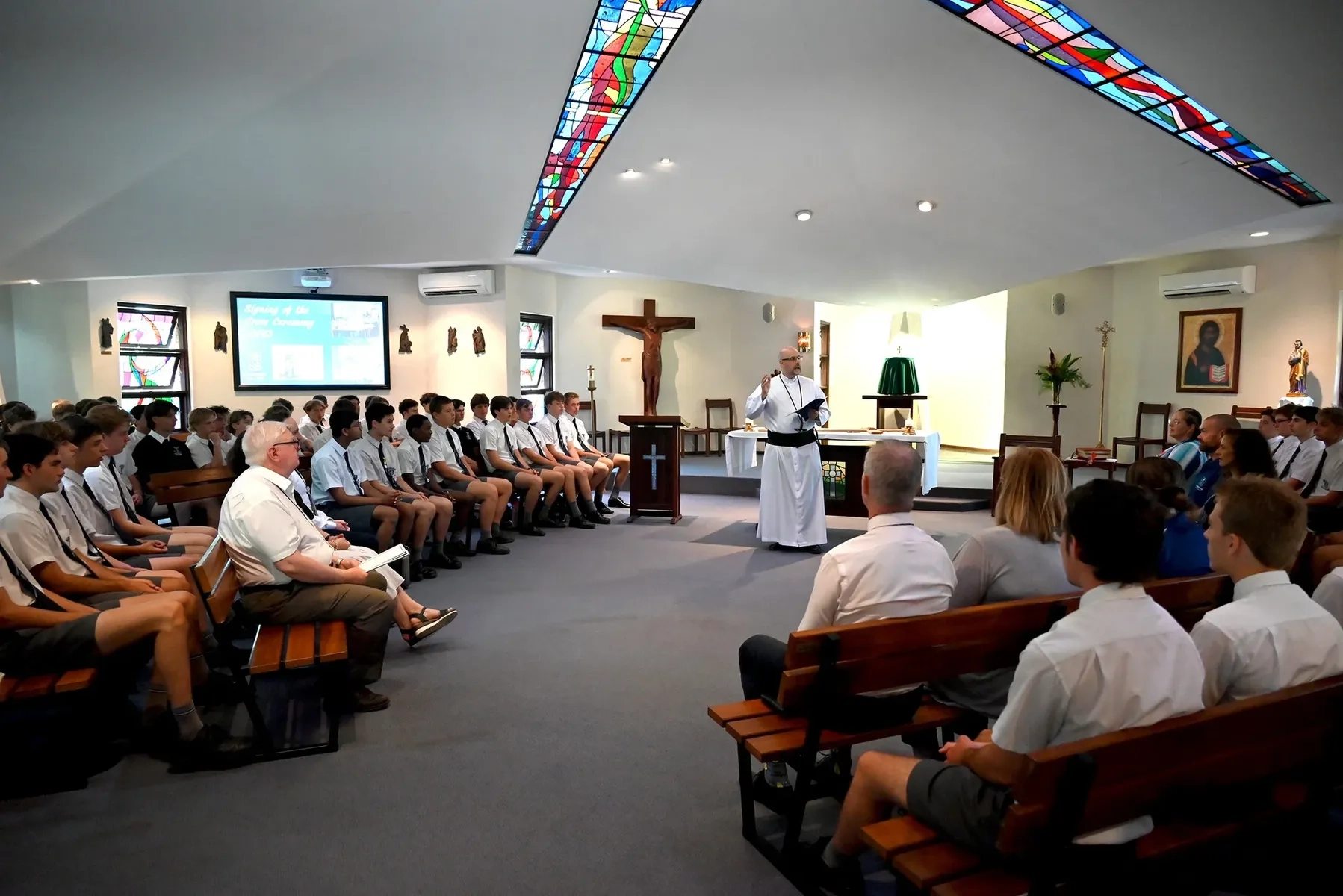 Father Fini OMI presenting Mass to students in the Chapel at Mazenod College Perth WA